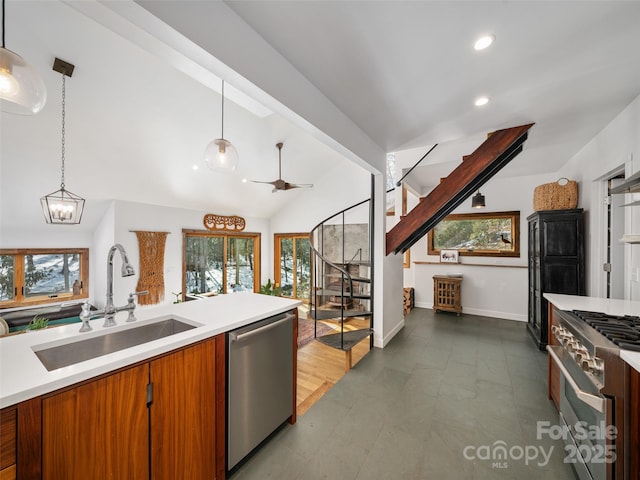 kitchen featuring sink, pendant lighting, lofted ceiling, and stainless steel appliances