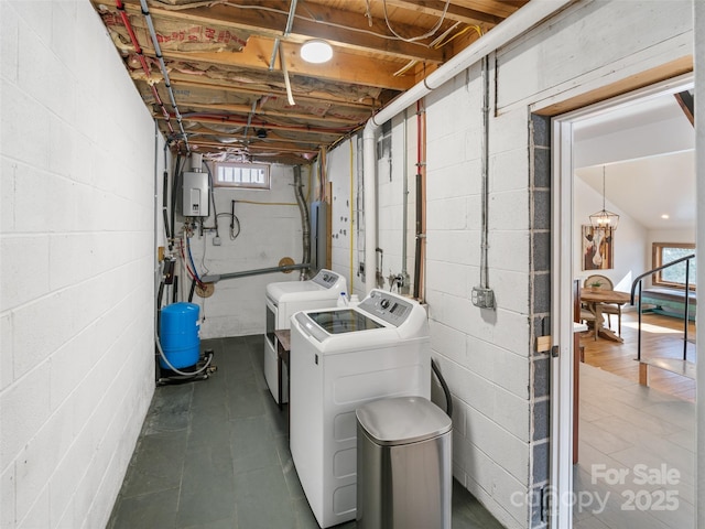 clothes washing area with water heater and washer and dryer