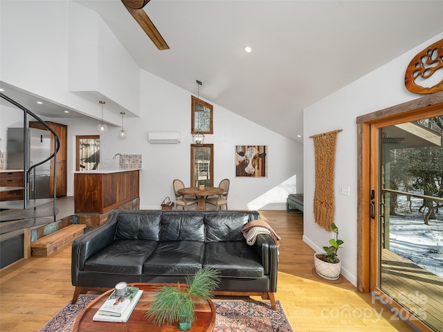 living room with a wall unit AC, lofted ceiling, and light hardwood / wood-style floors