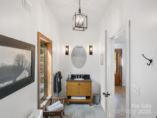 bathroom featuring a chandelier and vanity