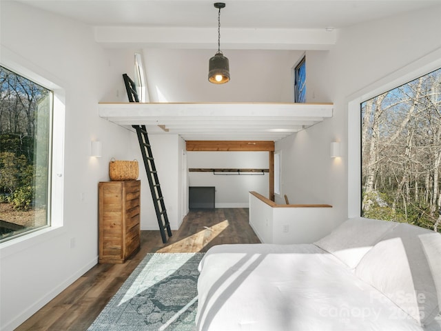 bedroom featuring a closet, dark hardwood / wood-style floors, and beamed ceiling