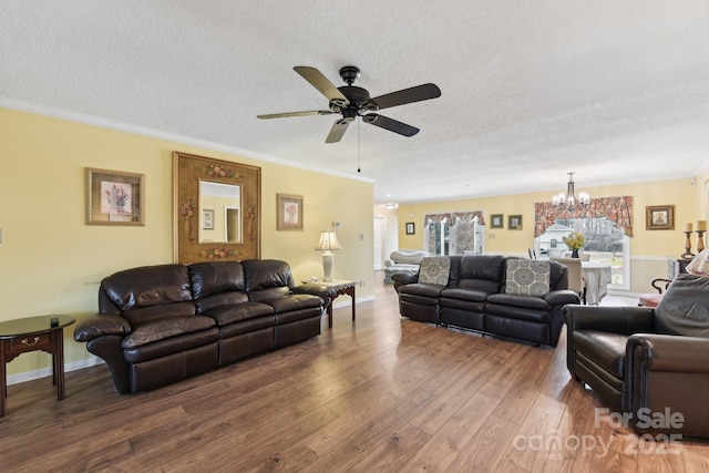 living room featuring crown molding, wood-type flooring, and a textured ceiling