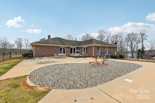 rear view of house featuring cooling unit and a patio area