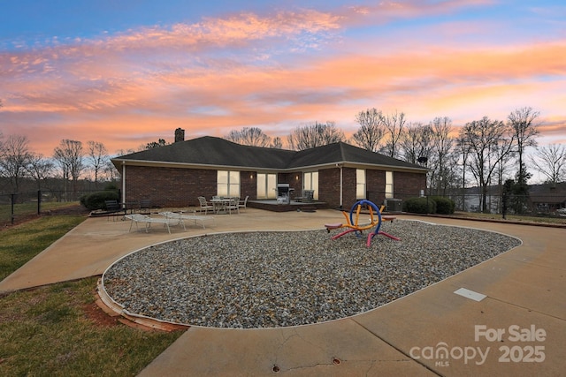 view of front facade featuring a patio and central AC unit