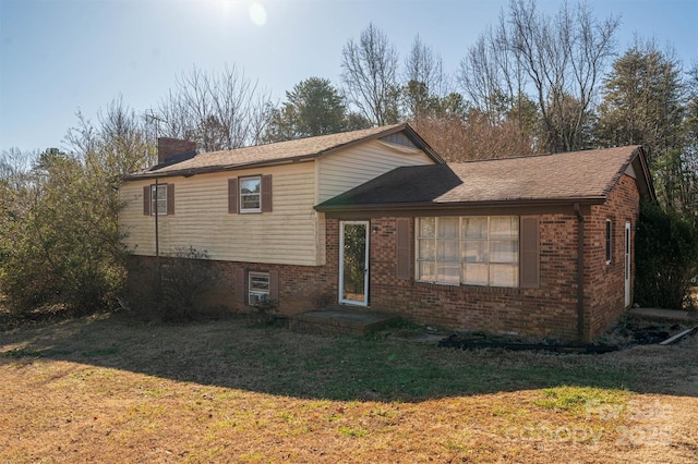 tri-level home with a front yard