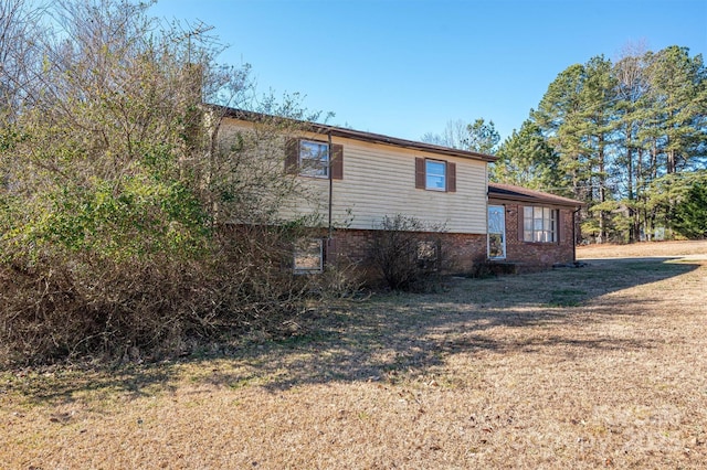 view of home's exterior with a yard