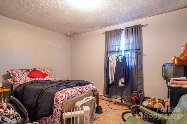 carpeted bedroom with a textured ceiling