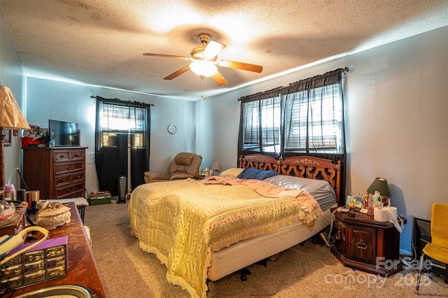 carpeted bedroom with a textured ceiling and ceiling fan