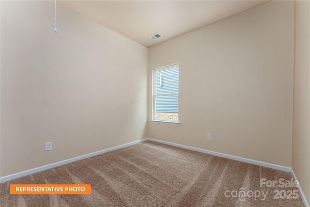 unfurnished room featuring visible vents, baseboards, and carpet