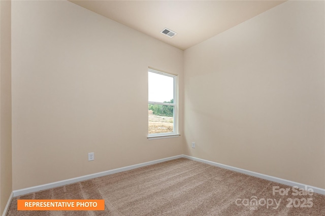 carpeted spare room with baseboards and visible vents