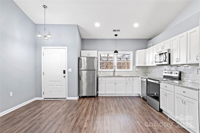 kitchen with white cabinetry, sink, decorative light fixtures, and appliances with stainless steel finishes