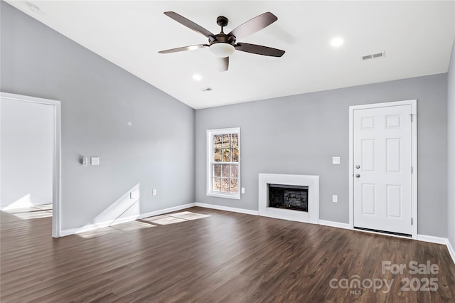 unfurnished living room with dark hardwood / wood-style floors and ceiling fan