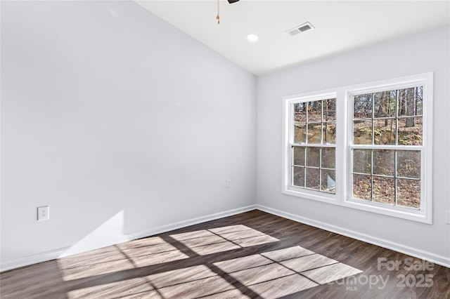 empty room featuring hardwood / wood-style flooring, lofted ceiling, and ceiling fan