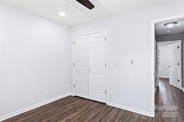 unfurnished bedroom featuring a closet, dark hardwood / wood-style floors, and ceiling fan