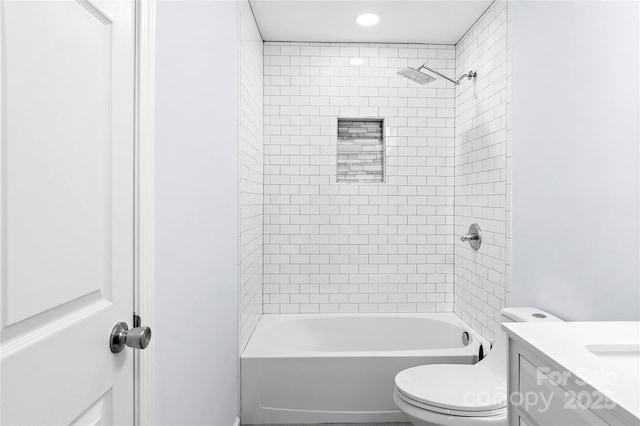 full bathroom featuring vanity, toilet, and tiled shower / bath combo