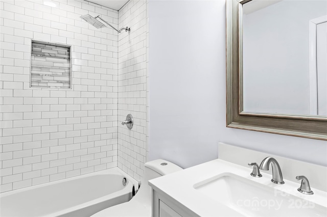 full bathroom featuring tiled shower / bath combo, vanity, and toilet