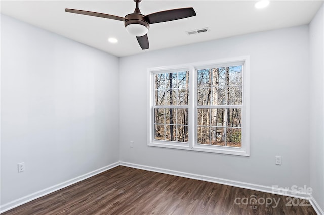 spare room with ceiling fan and dark hardwood / wood-style flooring