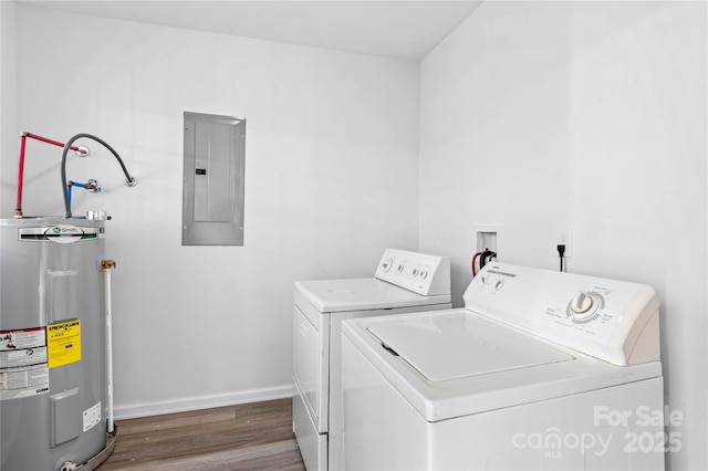 clothes washing area featuring water heater, dark hardwood / wood-style flooring, electric panel, and independent washer and dryer