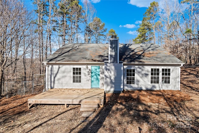 rear view of property featuring a wooden deck