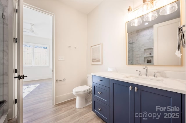 bathroom featuring vanity, toilet, hardwood / wood-style floors, and a shower