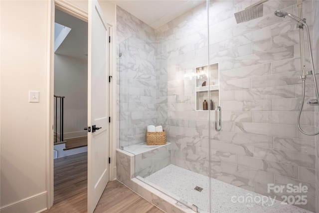 bathroom featuring walk in shower and hardwood / wood-style floors