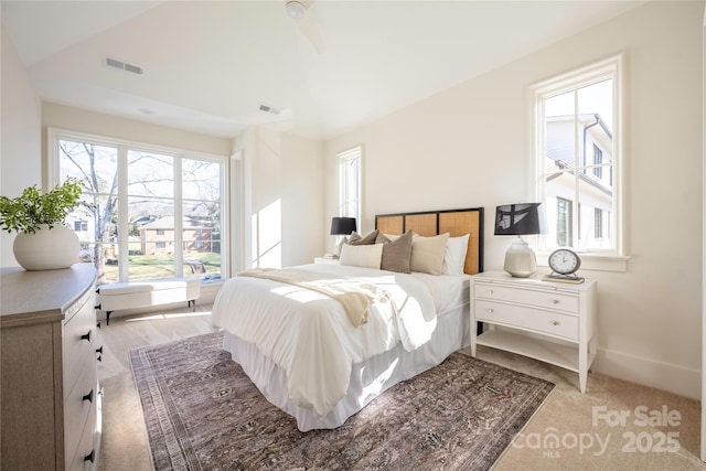 carpeted bedroom featuring lofted ceiling