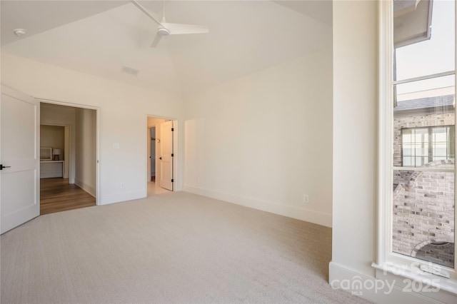 unfurnished bedroom with light carpet, lofted ceiling, and ceiling fan