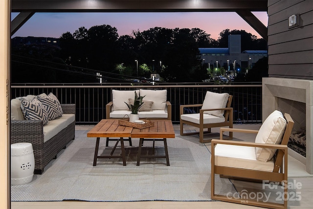 1214 S Kings Dr Unit A, Charlotte, NC 28207 - patio terrace at dusk featuring a balcony and an outdoor living space