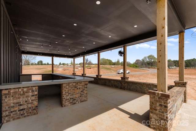 view of patio / terrace with exterior kitchen and a rural view