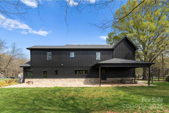 rear view of property with a yard and a patio