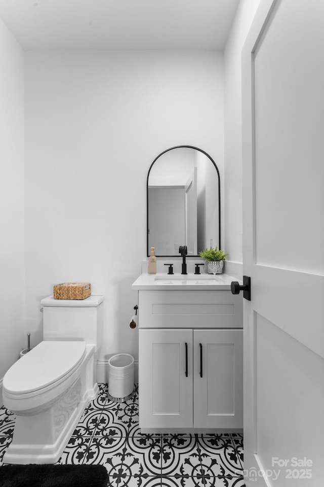 bathroom with vanity, tile patterned floors, and toilet