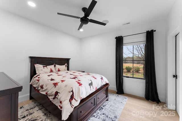 bedroom with light hardwood / wood-style floors and ceiling fan