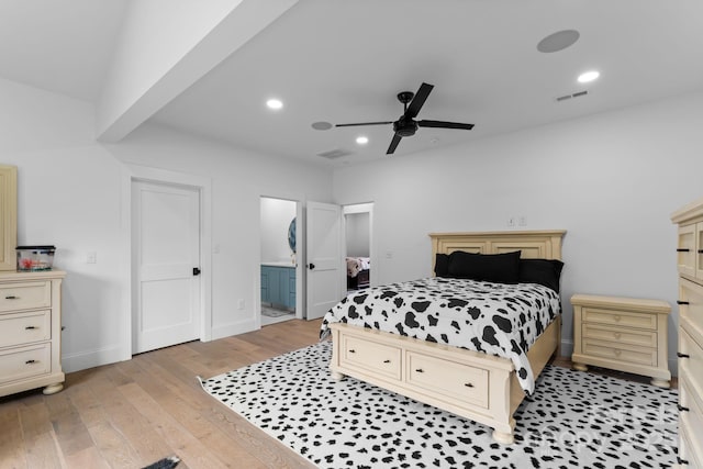 bedroom with ensuite bathroom, ceiling fan, and light wood-type flooring