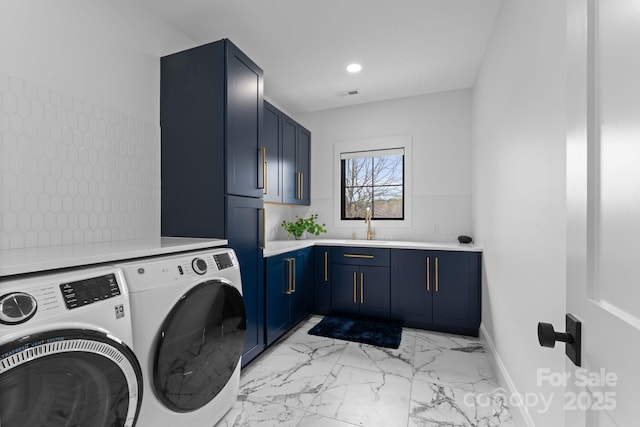 washroom featuring cabinets, sink, and washing machine and clothes dryer