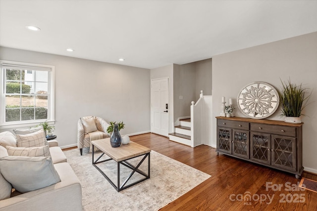 living room with dark hardwood / wood-style flooring