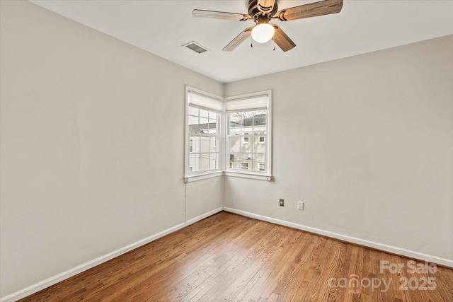 spare room featuring hardwood / wood-style floors and ceiling fan