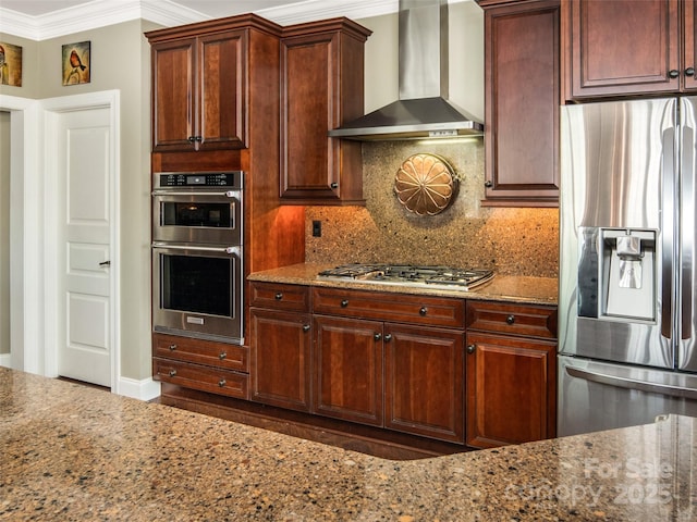 kitchen with light stone countertops, appliances with stainless steel finishes, tasteful backsplash, and wall chimney range hood