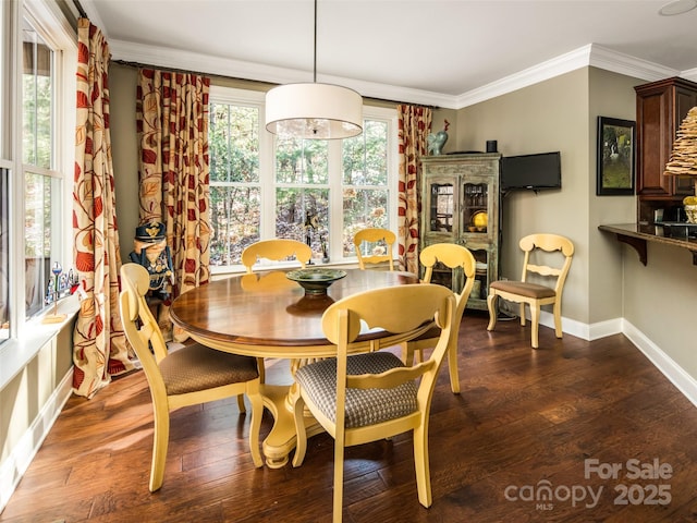 dining space featuring dark hardwood / wood-style floors and ornamental molding