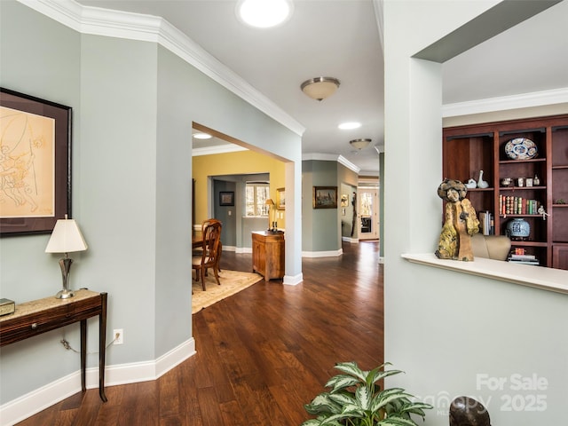 corridor with ornamental molding and dark hardwood / wood-style flooring