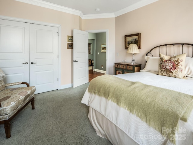 bedroom with a closet, ornamental molding, and dark colored carpet