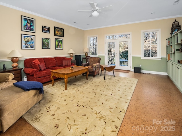 living room with ceiling fan, crown molding, and french doors