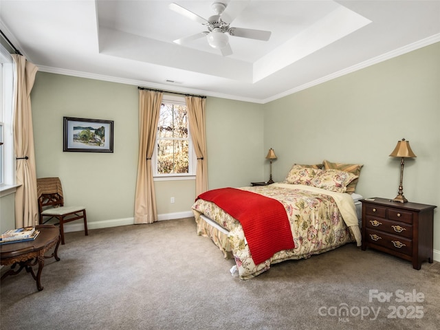 bedroom with ceiling fan, a tray ceiling, crown molding, and carpet flooring