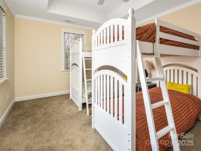 unfurnished bedroom with light carpet, ceiling fan, ornamental molding, and a raised ceiling