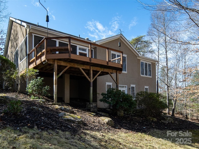 back of property featuring a wooden deck