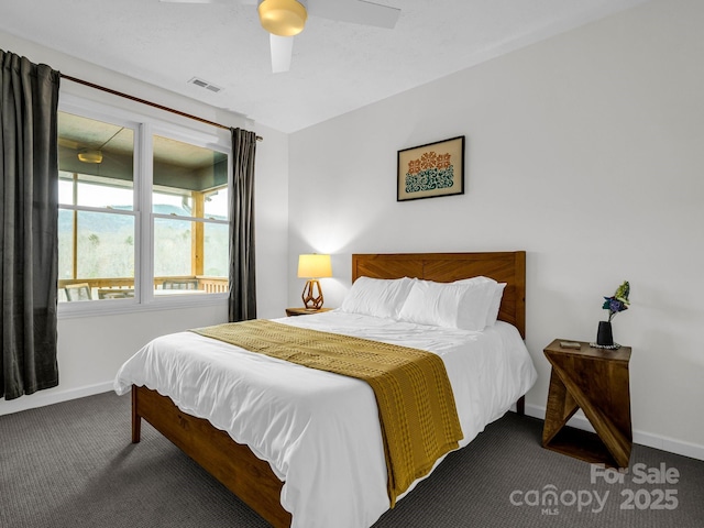 bedroom with ceiling fan and dark colored carpet