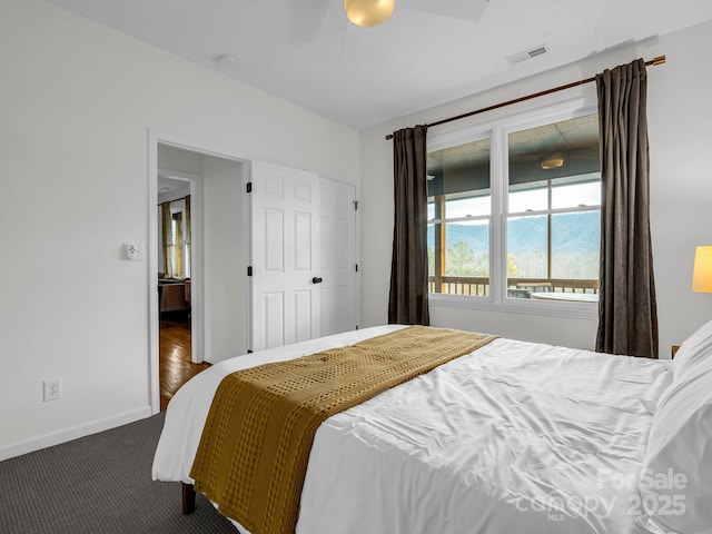 bedroom with ceiling fan and dark colored carpet