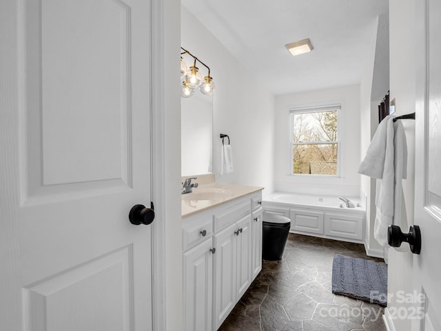 bathroom featuring vanity and a washtub