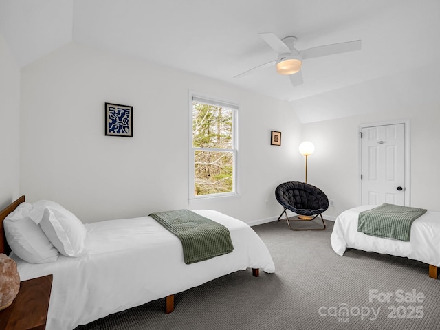 bedroom with ceiling fan, lofted ceiling, and carpet floors