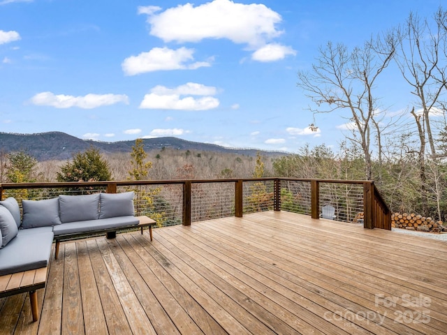 wooden deck featuring outdoor lounge area and a mountain view