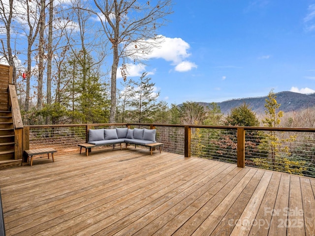 wooden deck featuring an outdoor living space and a mountain view